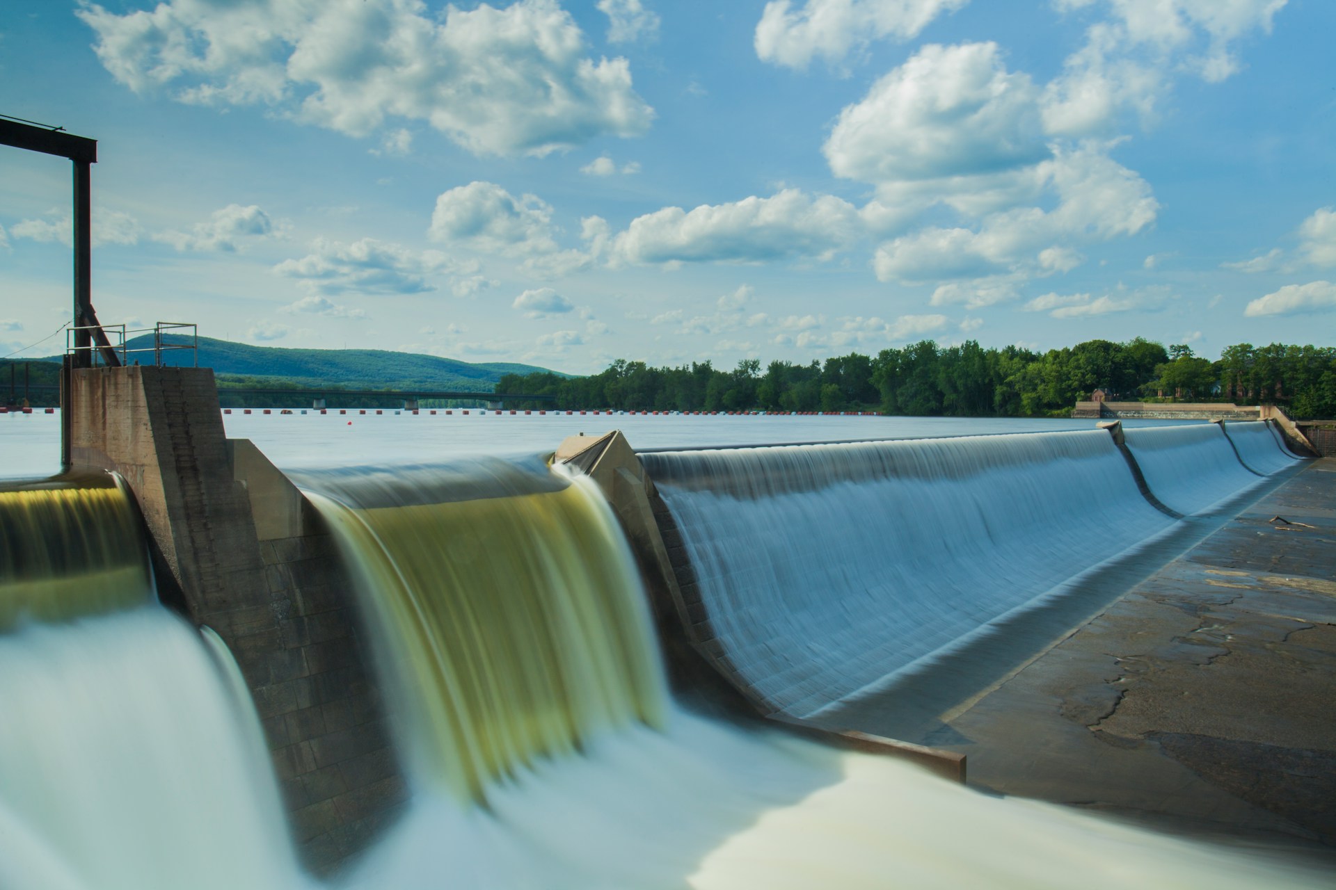 water dam under white and blue skies